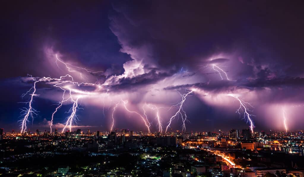 Lightning storm over city in purple light. Lightning-Proof Your Home